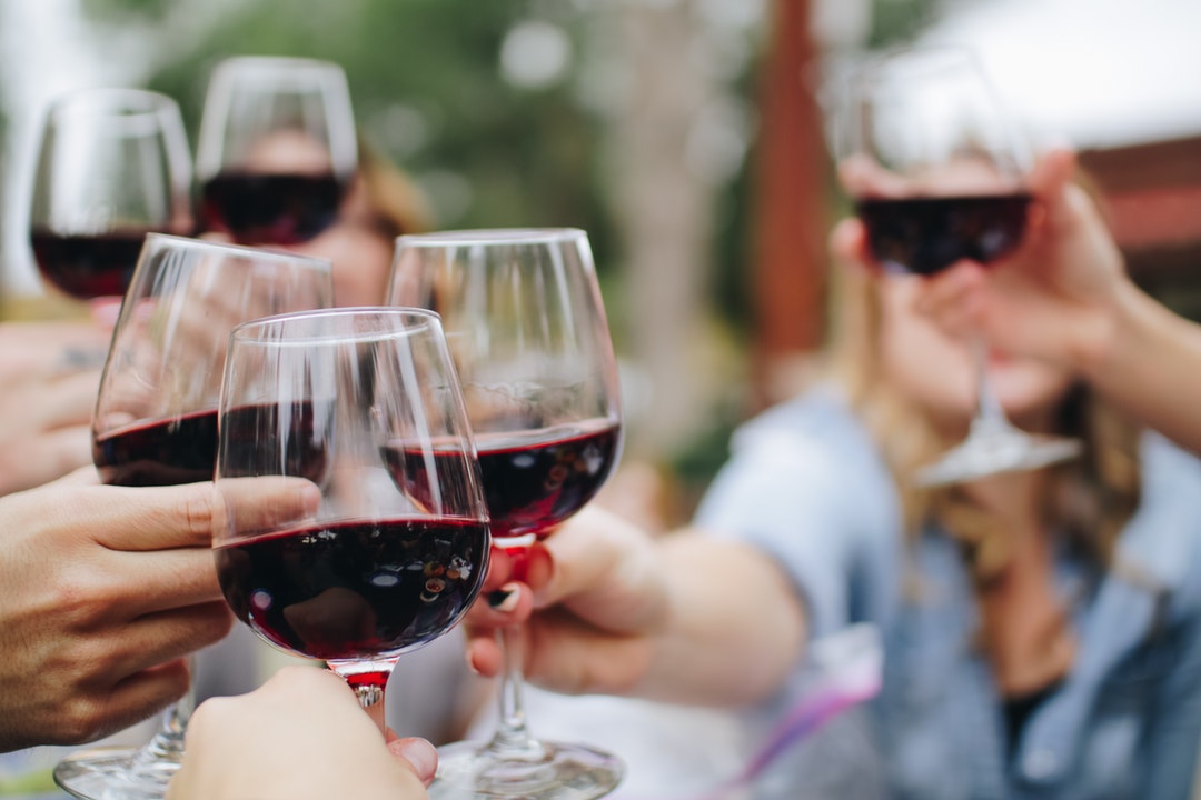 People in a wine club membership toasting
